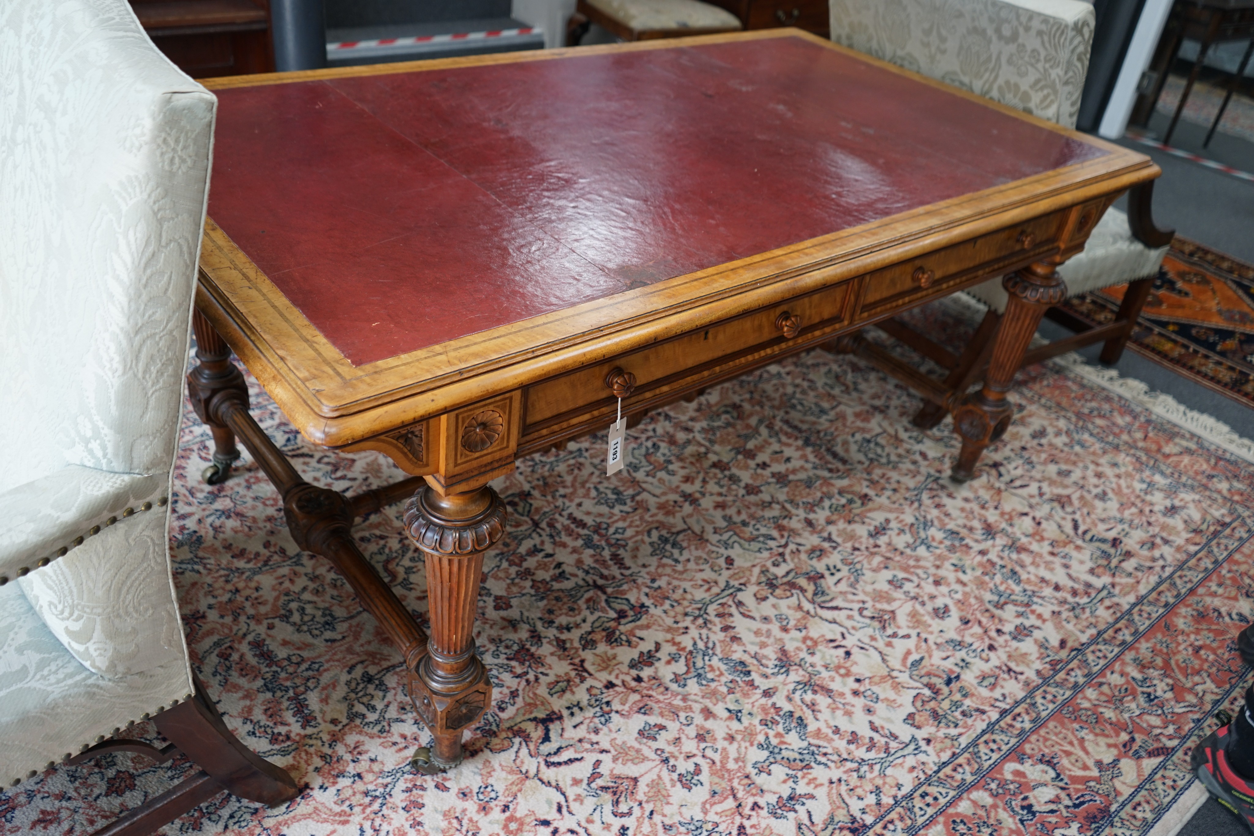 A late Victorian Holland & Sons banded satinwood two drawer library table, retailed by S & H Jewell, width 168cm, depth 96cm, height 76cm